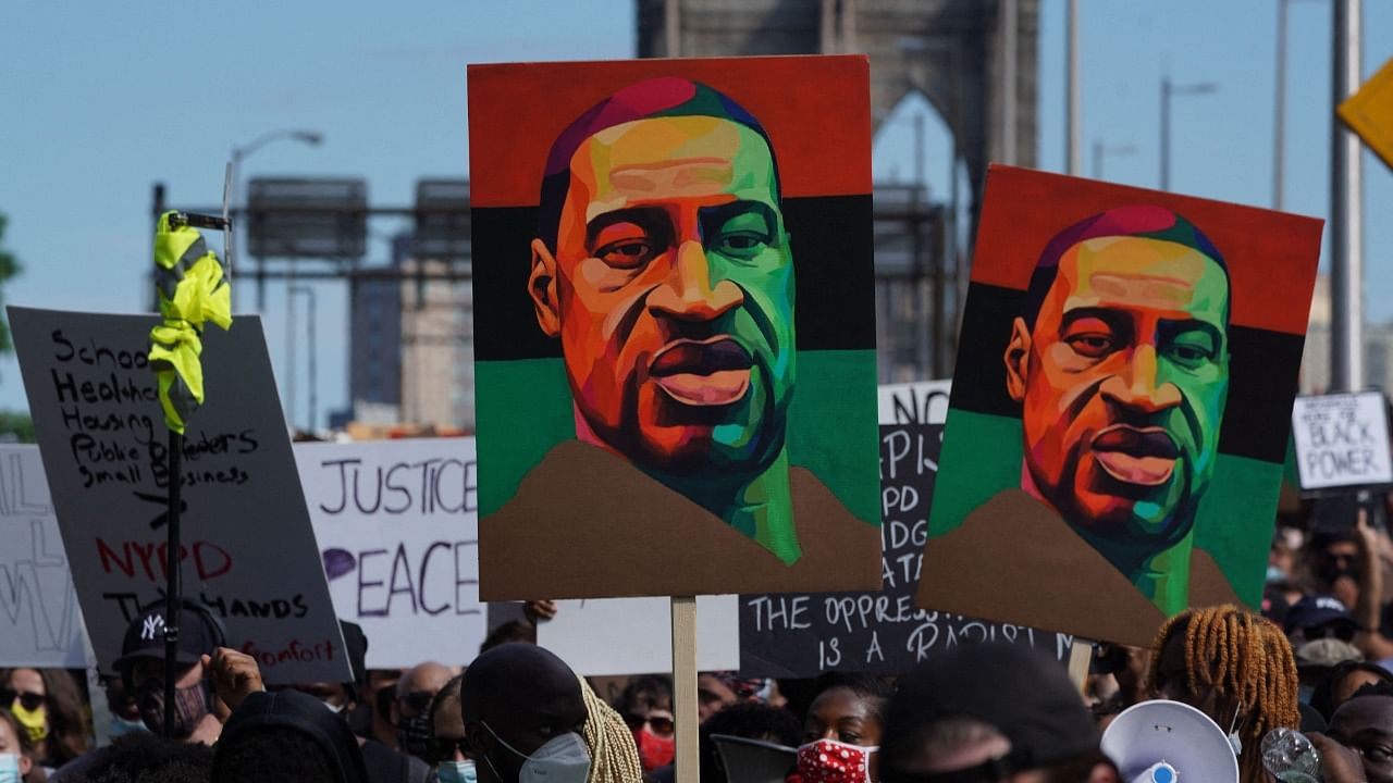 In this file photo taken on June 19, 2020 protesters march across the Brooklyn Bridge over the death of George Floyd by Minneapolis Police during a Juneteenth rally in New York. Credit: AFP File Photo