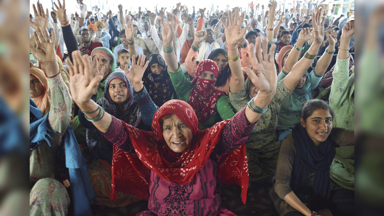 Farmers shout slogans during their ongoing protest against the new farm laws, at Ghazipur border in New Delhi, Friday, Feb. 26, 2021. Credit: PTI Photo