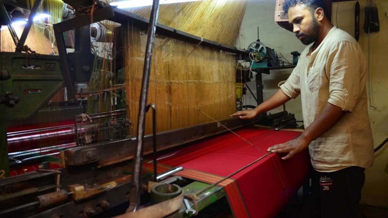 A weaver working on a handloom saree in Belagavi. Credit: DH File Photo.