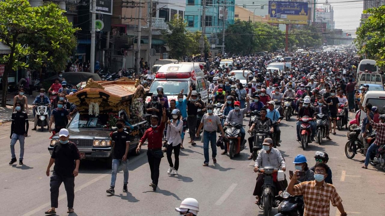 People attend the funeral procession for protester Kyal Sin, in Mandalay on March 4, 2021, a day after she was shot in the head while taking part in a demonstration against the military coup. Credit: AFP.