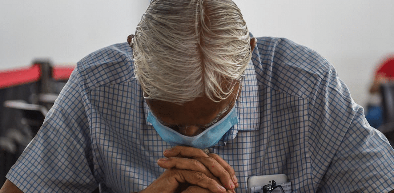 A senior citizen waits in a observation area after receiving a dose of a Covid-19 vaccine in Mumbai. Credit: AFP photo. 