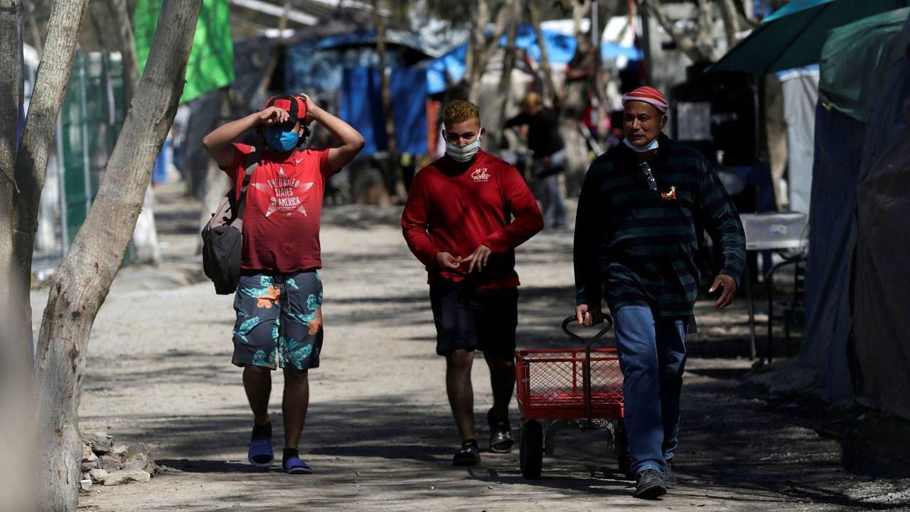 Migrants who traveled to northern Mexico seeking asylum in the United States, are pictured at a migrant encampment in Matamoros, Mexico February 20, 2021. Credit: Reuters File Photo