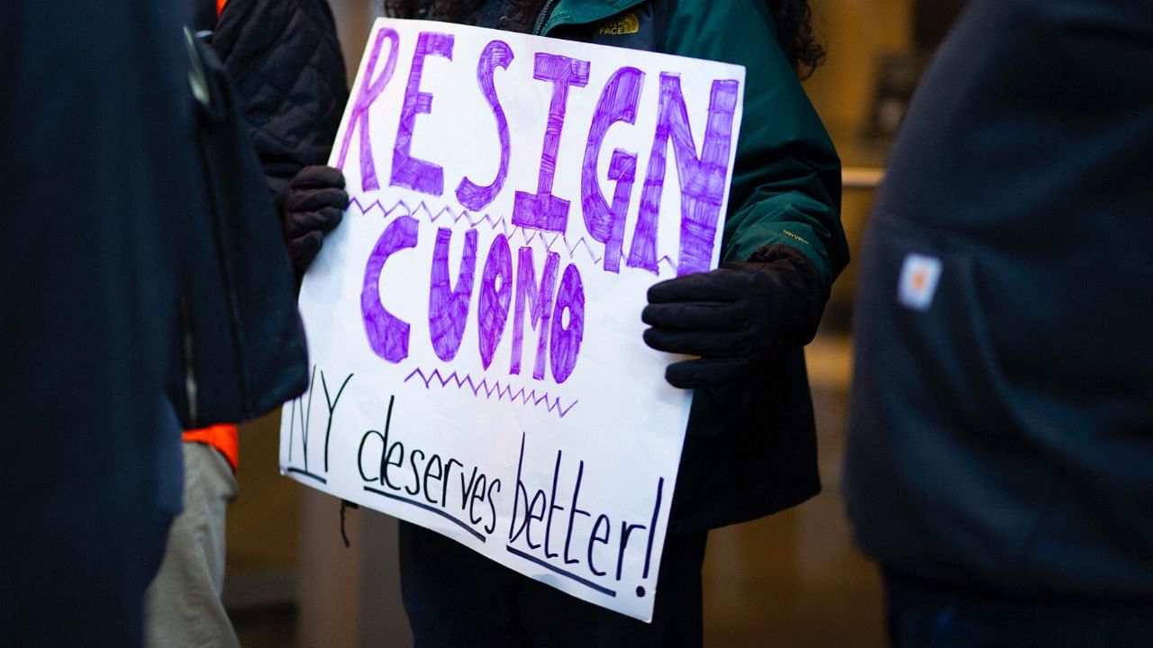 In this file photo taken on March 02, 2021 people attend a protest to demand New York Governor Andrew Cuomo's resignation after a third woman accused him of sexual harassment in New York City. Credit: AFP File Photo