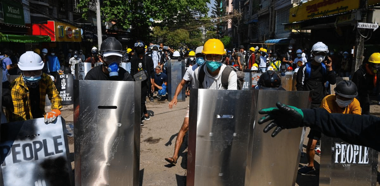 Protesters hold homemade shields during a demonstration against the military coup in Yangon. Credit: AFP Photo
