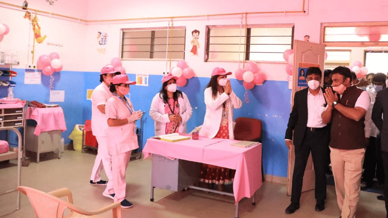 Donning sarees or salwar suits, masks and caps -- all in pink -- the women corona warriors painted the COVID-19 vaccination booth in the shade at the C V Raman Hospital here, that was inaugurated by Health Minister K Sudhakar. Credit: Twitter/@mla_sudhakar