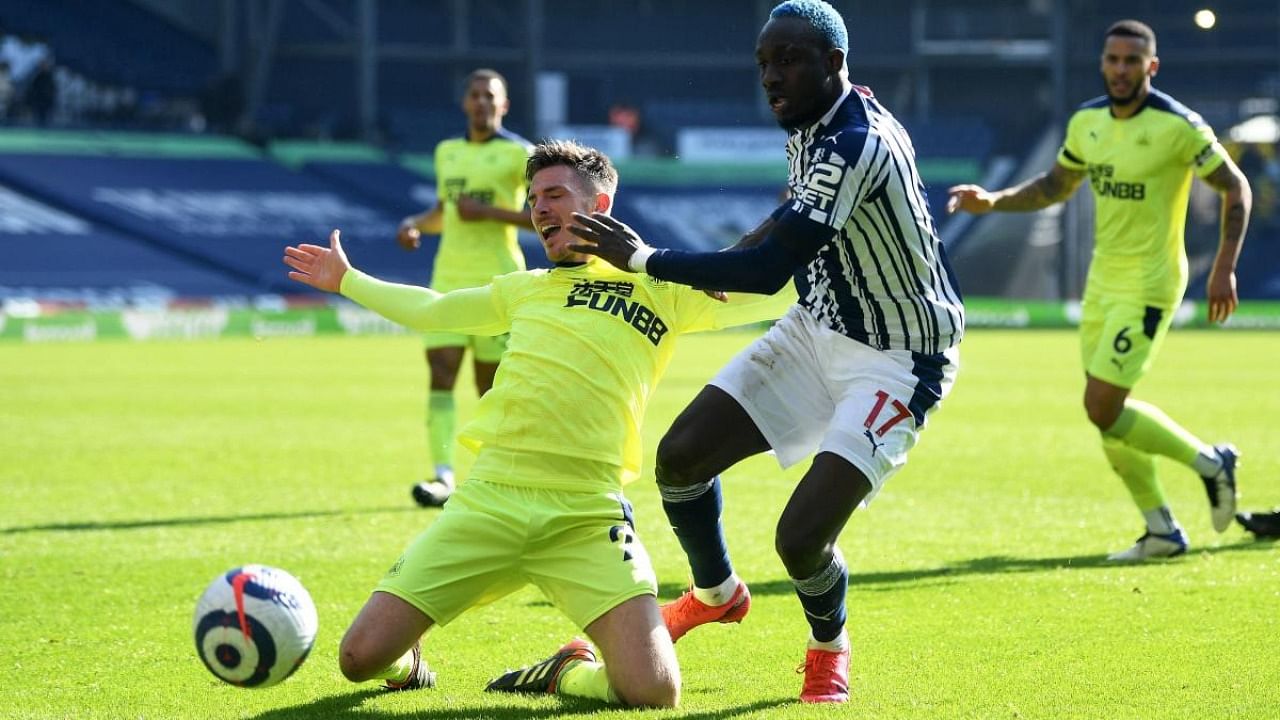 Newcastle United's Irish defender Ciaran Clark (L) vies with West Bromwich Albion's Senegalese striker Mbaye Diagne (R) during the English Premier League football match between West Bromwich Albion and Newcastle United at The Hawthorns stadium in West Bromwich. Credit: AFP.