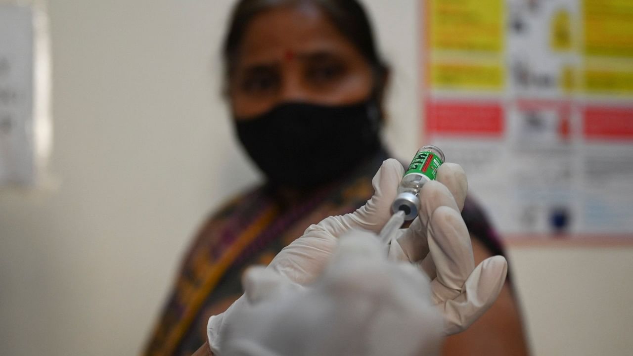 A health worker prepares to vaccinate a senior citizen with the Covid-19 coronavirus vaccine at a government hospital. Credit: AFP Photo