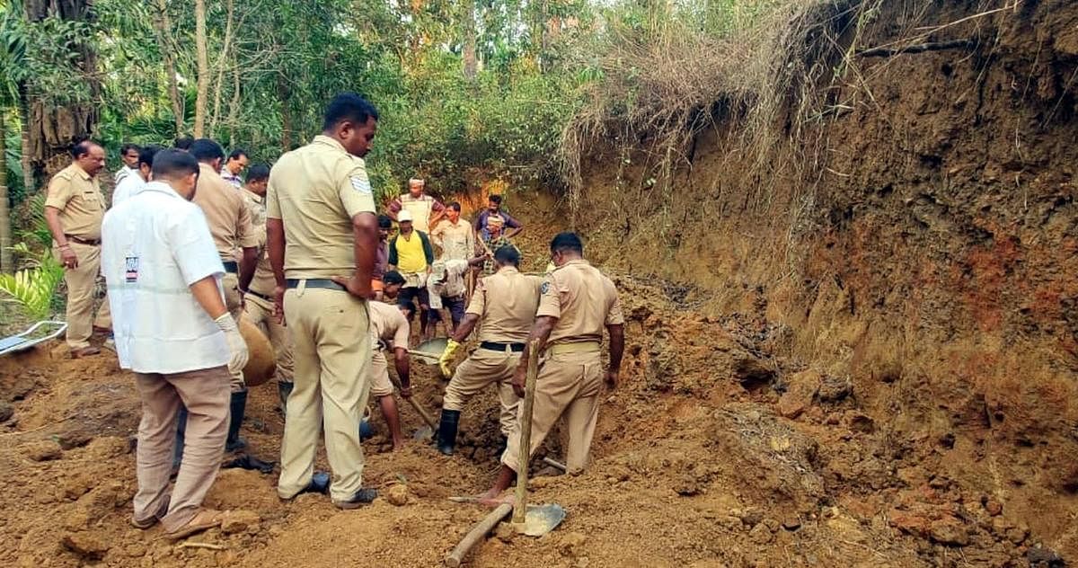 The police personnel carry out a operation to extricate bodies of the labourers buried alive under a heap of mud at Sampebailu in Yellapur taluk on Monday. Credit: DH Photo