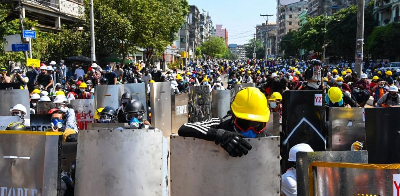 Protesters hold homemade shields during a demonstration against the military coup in Yangon on March 8, 2021. Credit: AFP Photo