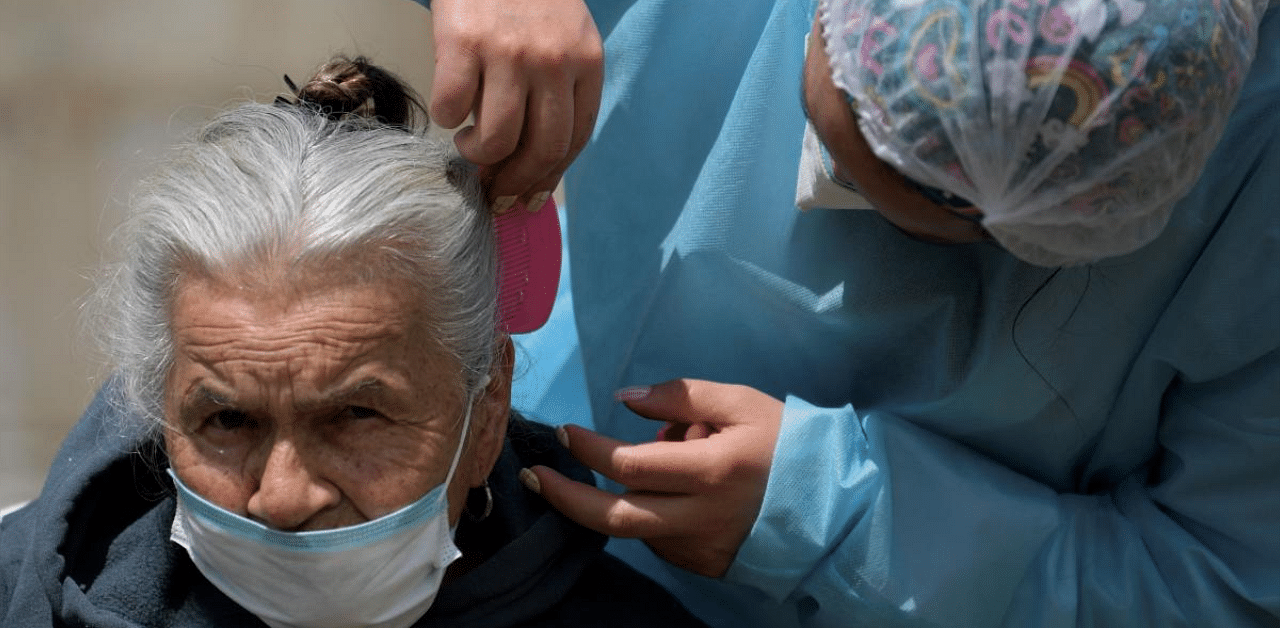 A old woman is attended by health member after receives a dose of the Sinovac vaccine. Credit: AFP photo. 