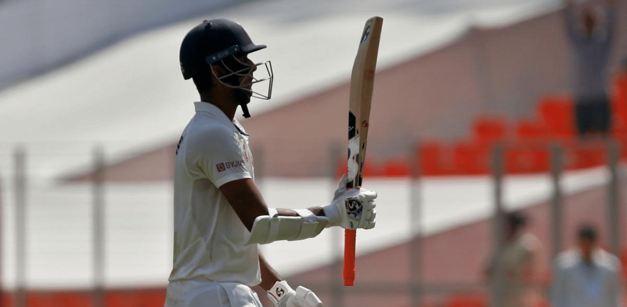 Washington Sundar raises his bat to acknowledge the spectators as he walks off the field during fourth Test against England. Credit: Reuters photo. 