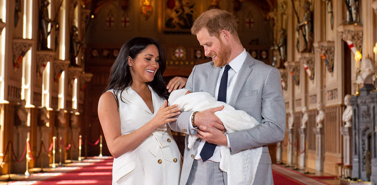 Britain's Prince Harry, Duke of Sussex (R), and his wife Meghan, Duchess of Sussex, pose for a photo with their son, Archie Harrison Mountbatten-Windsor, in St George's Hall at Windsor Castle in Windsor. Credit: AFP File Photo