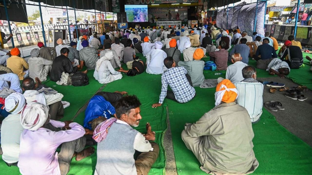 Farmers listen to their leaders as they continue their protest against the central government's recent agricultural reforms along a blocked highway at Gazipur Delhi-Uttar Pradesh state border. Credit: AFP.