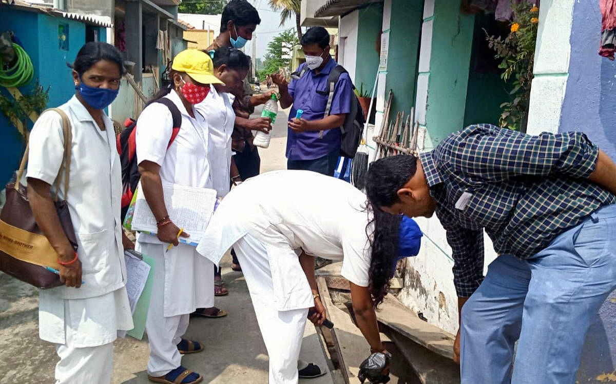 Health personnel check mosquito larvae breeding. DH FILE PHOTO