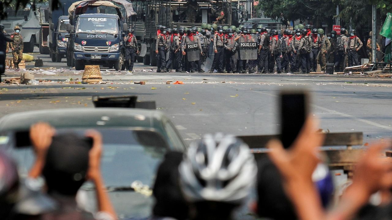 Police stand on a road during an anti-coup protest in Myanmar. Credit: Reuters