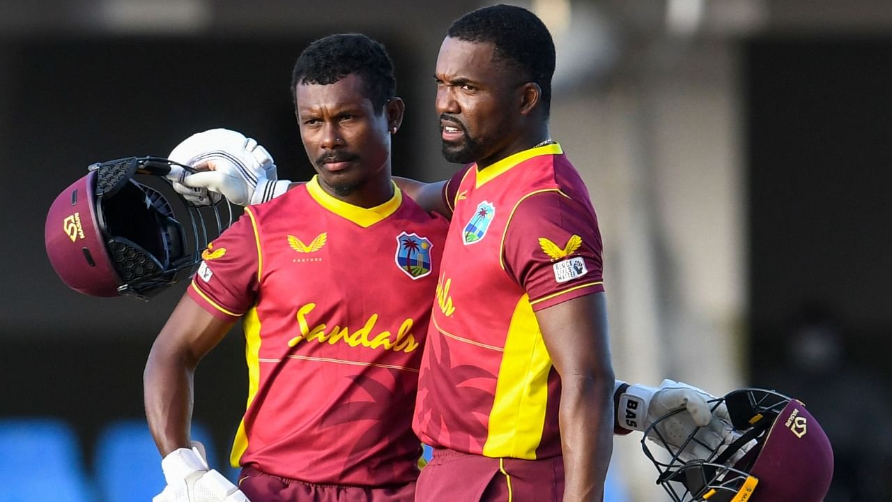 Jason Mohammed (L) and Darren Bravo (R) of West Indies celebrate winning the 1st ODI match between West Indies and Sri Lanka at Vivian Richards Cricket Stadium in North Sound, Antigua and Barbuda, on March 10, 2021. Credit: AFP Photo