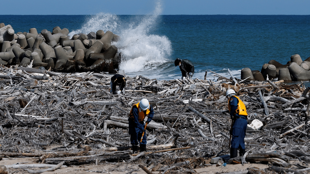 Japan's coast guards look for the remains of people who went missing after the 2011 earthquake and tsunami that killed thousands and triggered the worst nuclear accident since Chernobyl. Credit: Reuters Photo