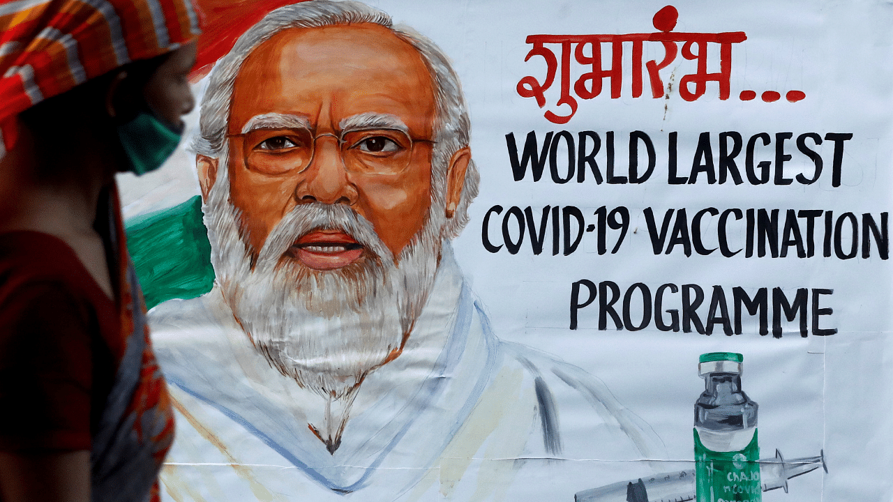 A woman walks past a painting of Indian Prime Minister Narendra Modi. Credit: Reuters Photo