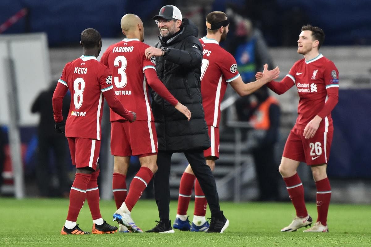 Jurgen Klopp and players react at the final whistle during the UEFA Champions league Last 16 2nd Leg football match between Liverpool and RB Leipzig at Puskas Arena in Budapest, Hungary. Credit: AFP photo. 