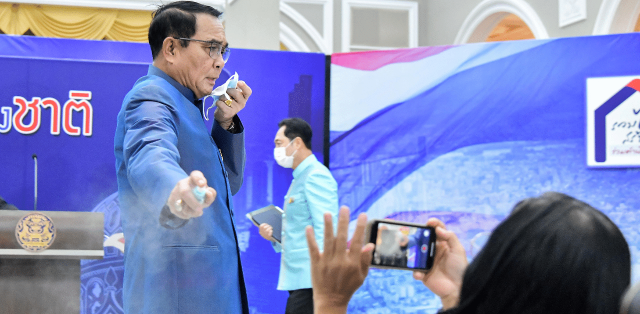 Thai Prime Minister Prayuth Chan-ocha sprays hand sanitizer at front row journalists to avert answering questions on the latest Cabinet reshuffle in Bangkok. Credit: Reuters Photo