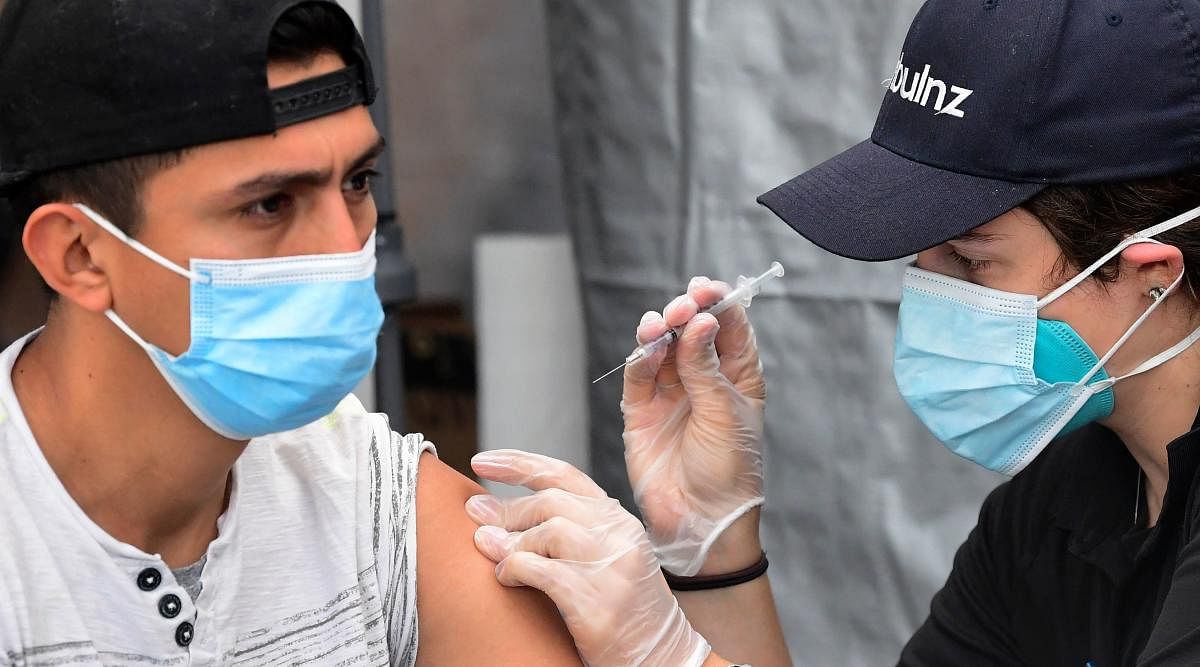 People receive the Pfizer Covid-19 vaccine at a public housing project pop-up site targeting vulnerable communities in Los Angeles, California. Credit: AFP photo. 