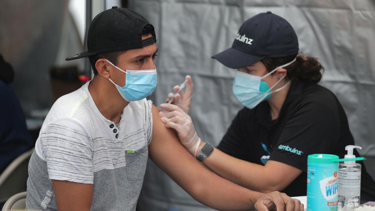 A man receives a coronavirus vaccination, at Jordan Downs in Los Angeles, California. Credit: Reuters.