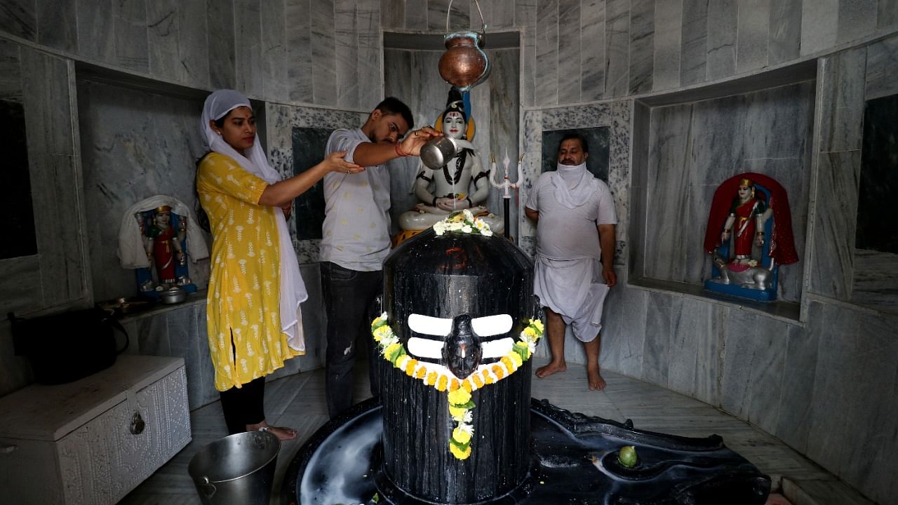 Hindu devotees pour milk over a Shivling at a temple during the Mahashivratri festival. Credit: Reuters