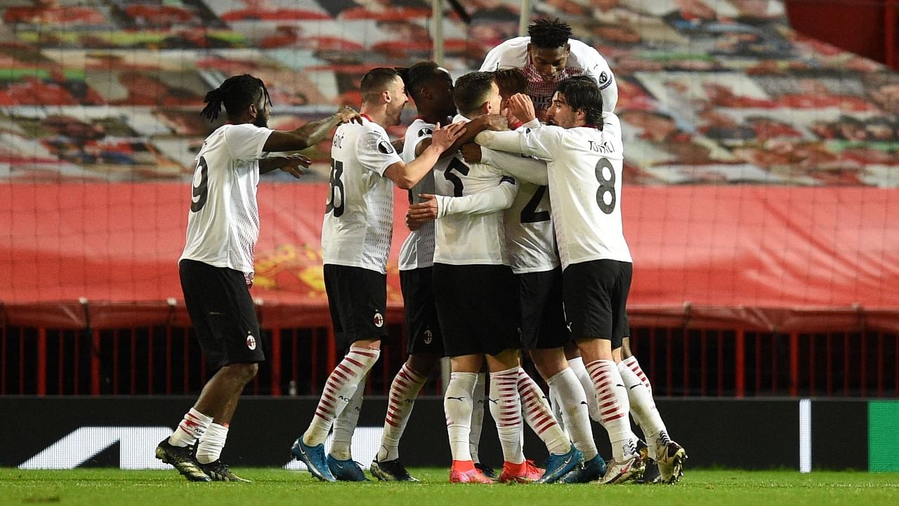 AC Milan players their first goal, a late equaliser to make the score 1-1, during the UEFA Europa League round of 16 first leg football match between Manchester United and AC Milan at Old Trafford in Manchester. Credit: AFP Photo