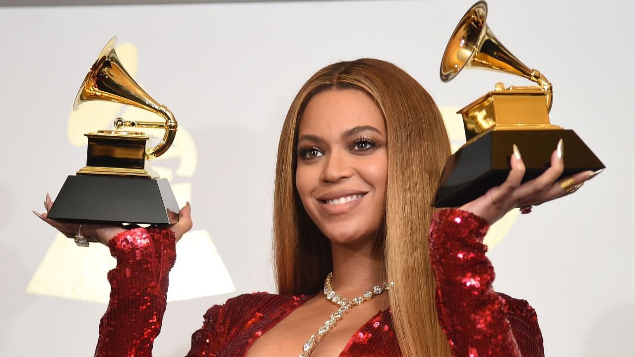 Singer Beyonce poses with her Grammy trophies during the 59th Annual Grammy music Awards. Credit: AFP File Photo