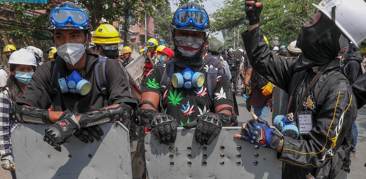  Anti-coup protesters with makeshift shields. Credit: AP Photo