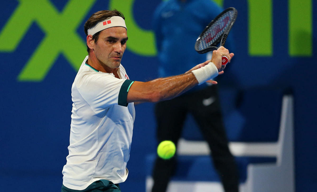 Roger Federer returns the ball during his match with Nikoloz Basilashvili of Georgia at the Qatar ExxonMobil Open. Credit: AFP photo. 