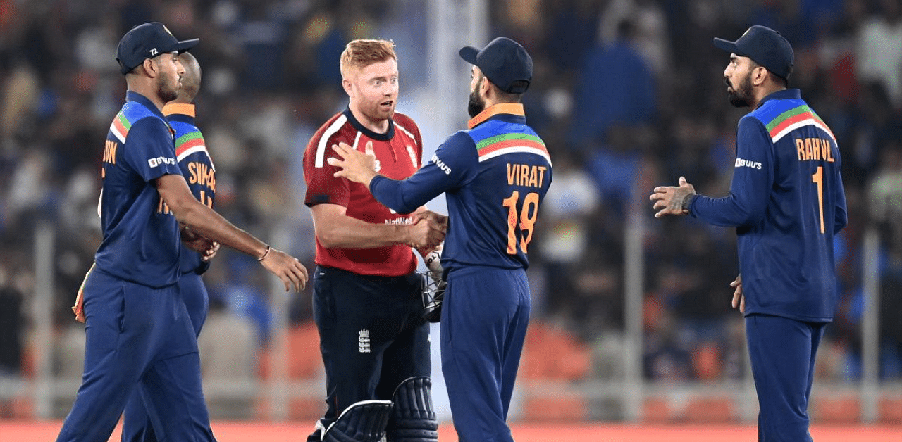 England's Jonny Bairstow (2L) shakes hands with India's captain Virat Kohli at the end of the first Twenty20 international cricket match between India and England at the Narendra Modi Stadium in Motera. Credit: AFP photo. 