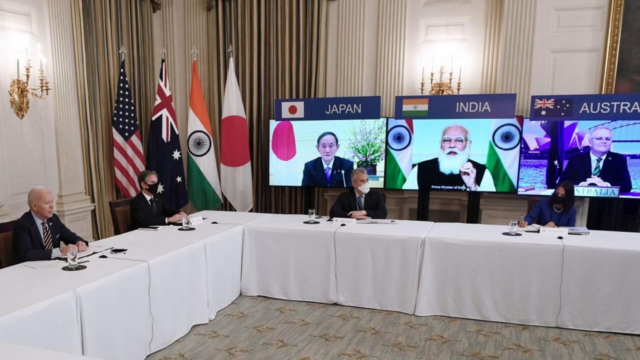 US President Joe Biden (L), with Secretary of State Antony Blinken (2nd L), meets virtually with members of the "Quad" alliance of Australia, India, Japan and the US, in the State Dining Room of the White House in Washington, DC. Credit: AFP.