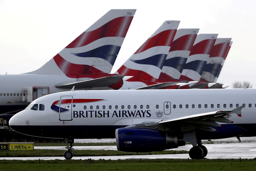 A British Airways plane taxis past tail fins of parked aircraft at Heathrow Airport in London. Credit: Reuters Photo