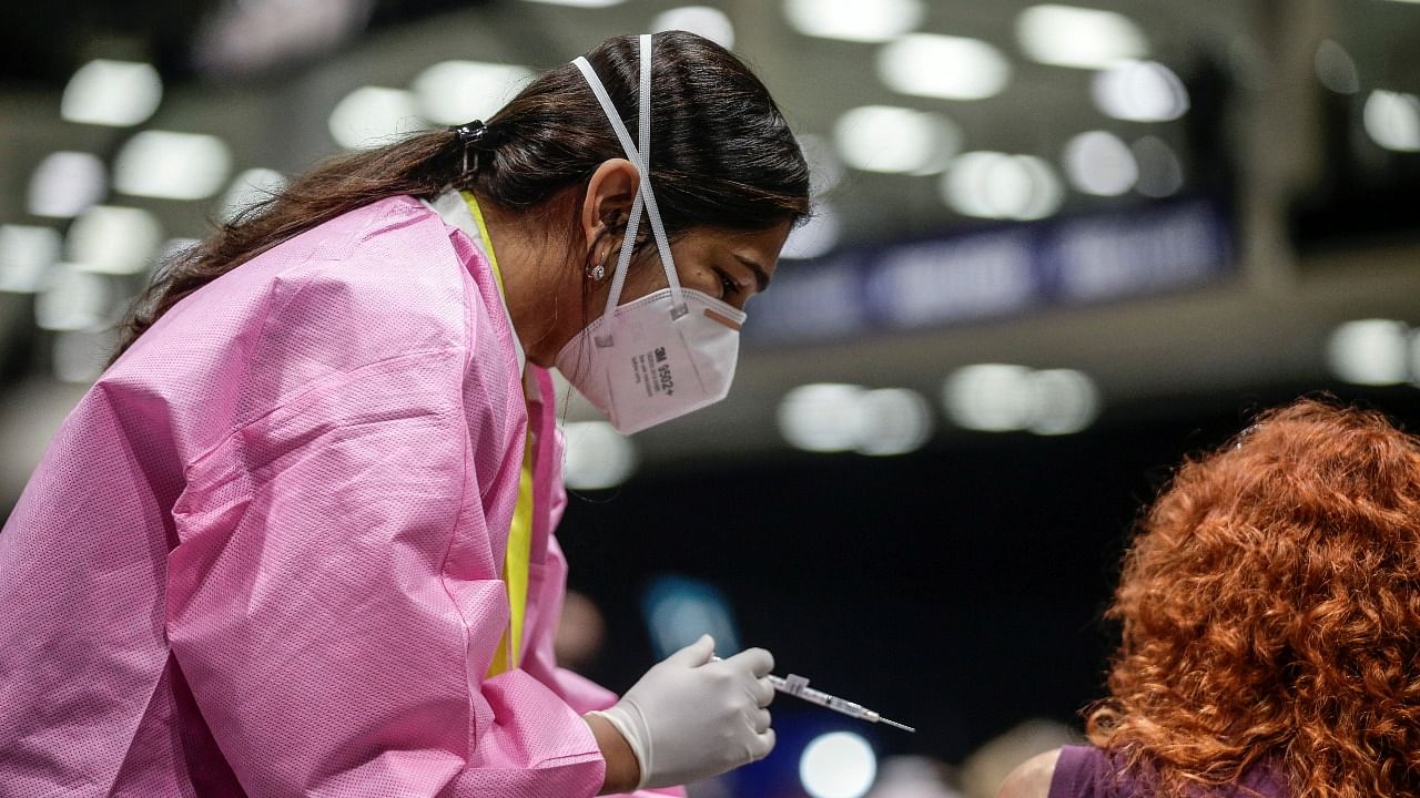 A health worker administers a coronavirus vaccine at a mass vaccination site at Lumen Field Event Center in Seattle, Washington, US. Credit: Reuters Photo