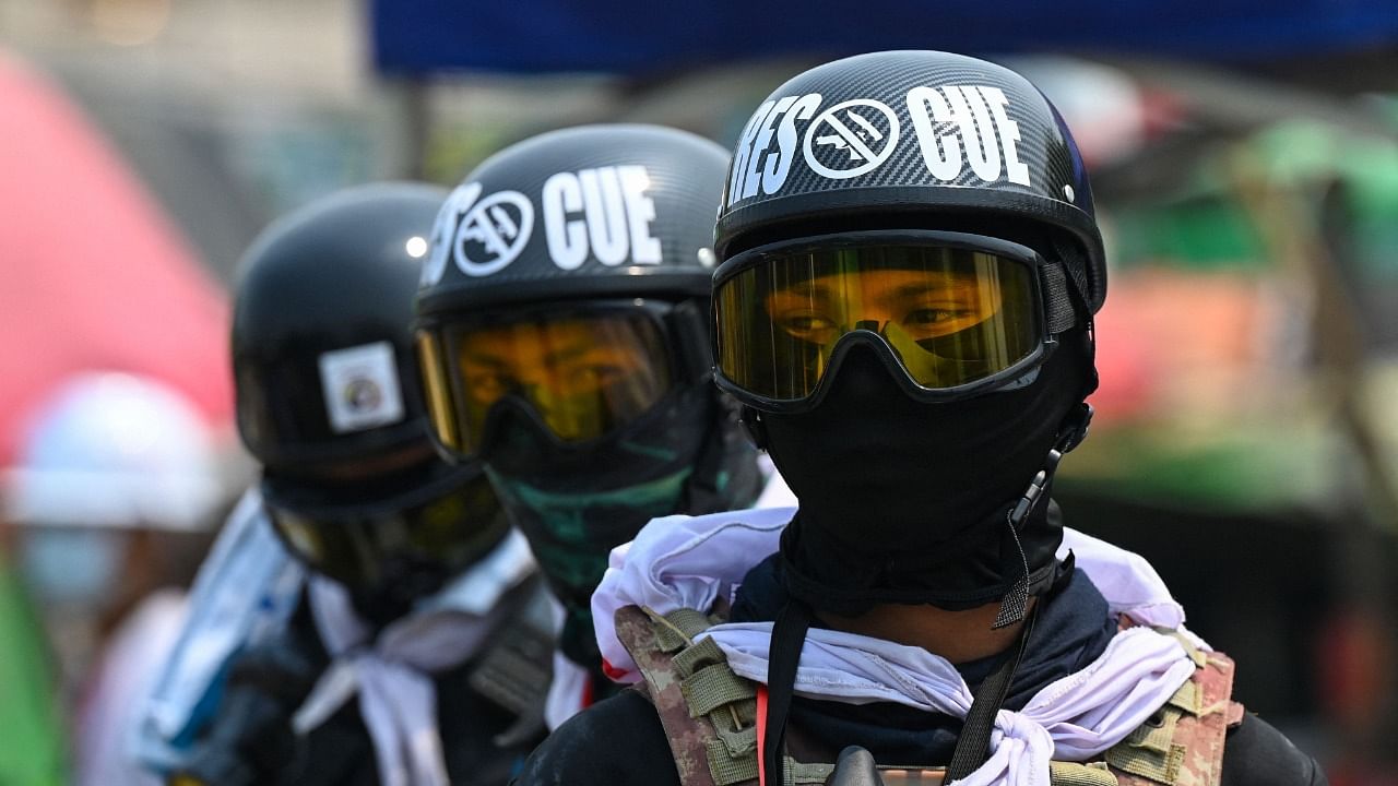 Frontline protesters keep watch in Yangon on March 13, 2021, as security forces continue to crackdown on demonstrations against the military coup. Credit: AFP Photo