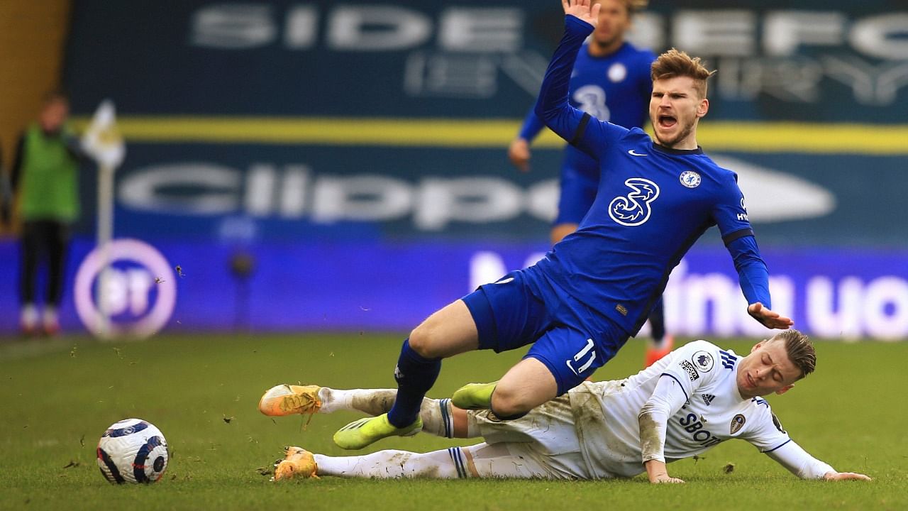 Chelsea's Timo Werner, left, is tackled by Leeds United's Ezgjan Alioski during the English Premier League soccer match between Leeds United and Chelsea at Elland Road stadium, in Leeds, England. Credit: AP/PTI Photo