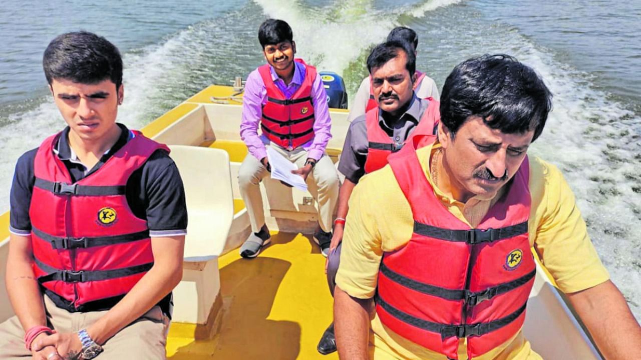 Karnataka Tourism Minister C P Yogeeshwara (R) on a boat ride at Varuna Lake in Mysuru taluk, Mysuru district, on Saturday. Credit: DH Photo