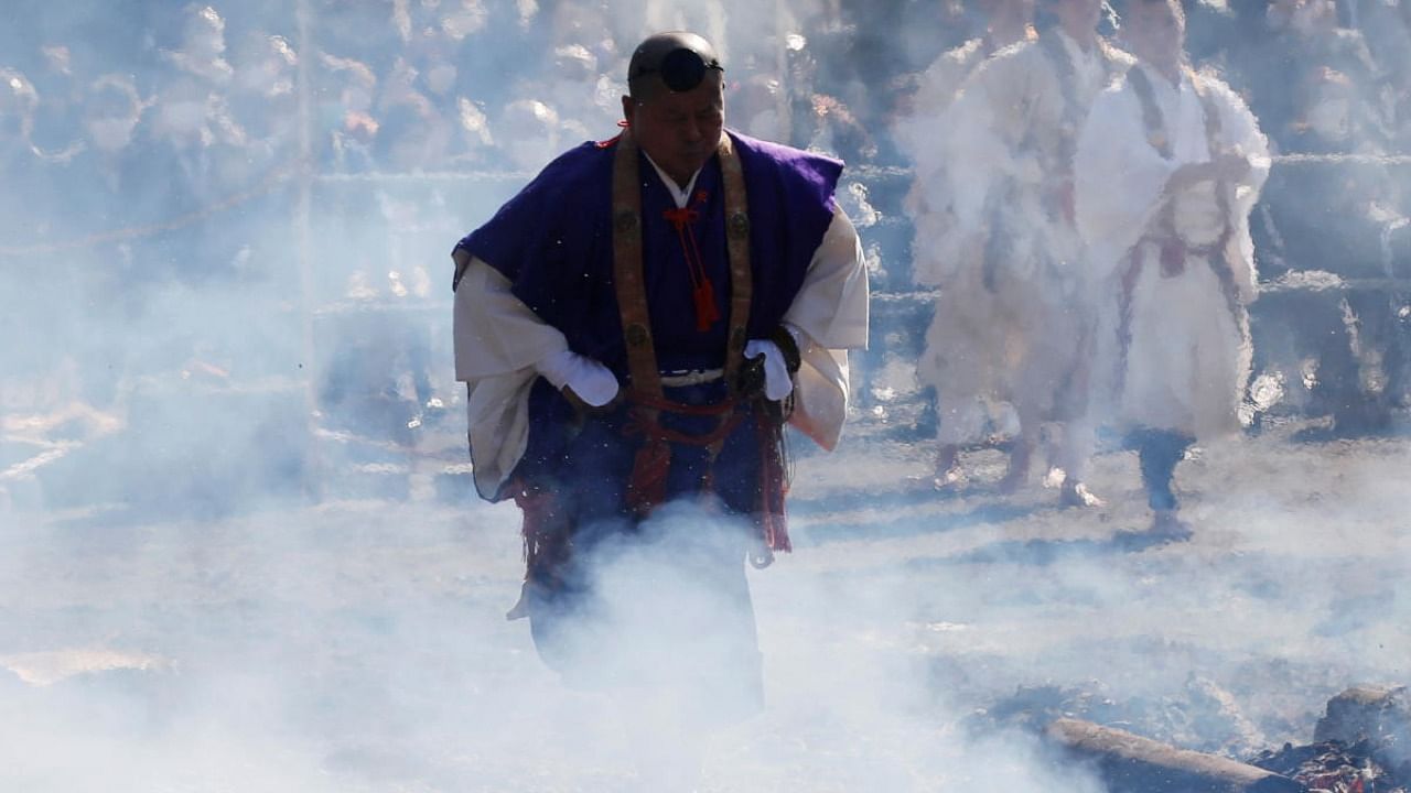 A Buddhist monk walks across smoldering hot ground at the fire-walking festival, called hiwatari matsuri in Japanese, at Mt.Takao in Tokyo. Credit: Reuters.