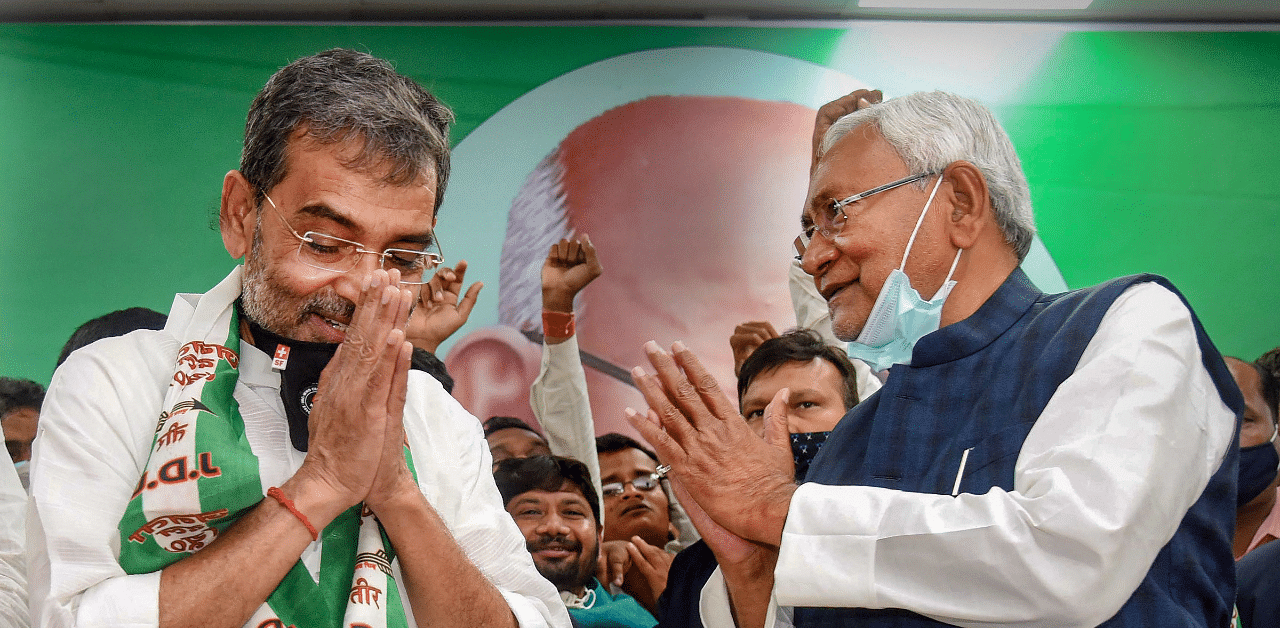Bihar Chief Minister Nitish Kumar felicitates RLSP President Upendra Kushwaha after the party merged with JD(U), in Patna. Credit: PTI Photo