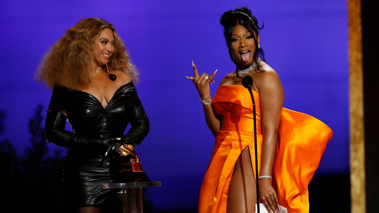 In this handout photo courtesy of CBS Broadcasting, (L-R) Beyonce and Megan Thee Stallion accept the Best Rap Performance award for "Savage" onstage during the 63rd Annual GRAMMY Awards at Los Angeles Convention Center on March 14, 2021 in Los Angeles, California. Credit: AFP Photo