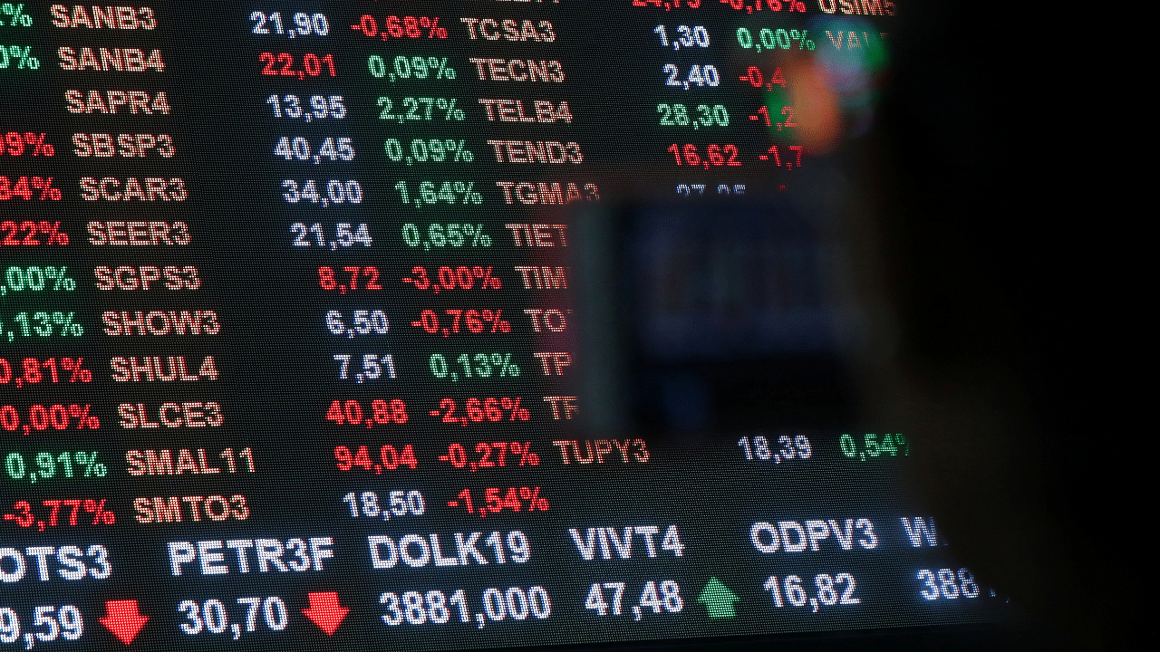 A woman looks at an electronic board showing the recent fluctuations of market indices on the floor of Brazil's B3 Stock Exchange in Sao Paulo. Credit: Reuters Photo