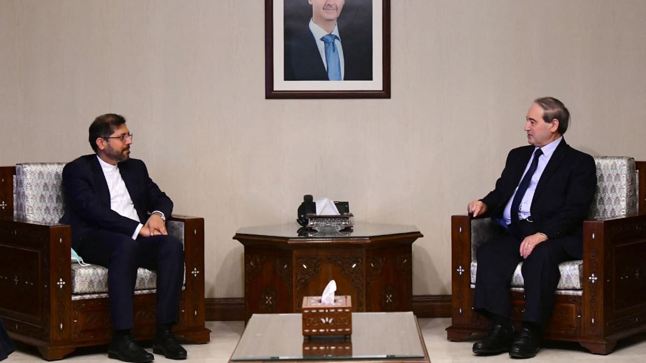 Syrian FM Faisal Mekdad (right). Credit: AFP/handout/SANA.