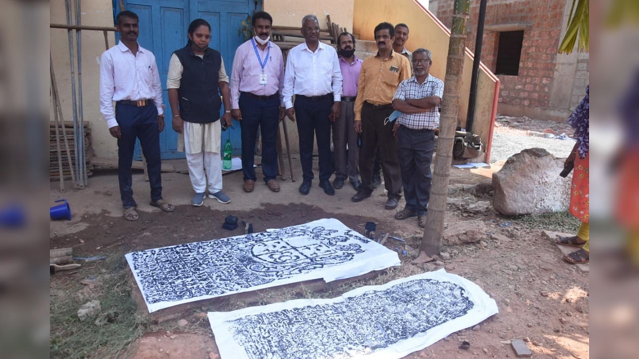 Experts taking estampage of the two inscriptions found at technology wing campus of College of Fisheries at Hoige Bazar in Mangaluru. Credit: DH Photo.