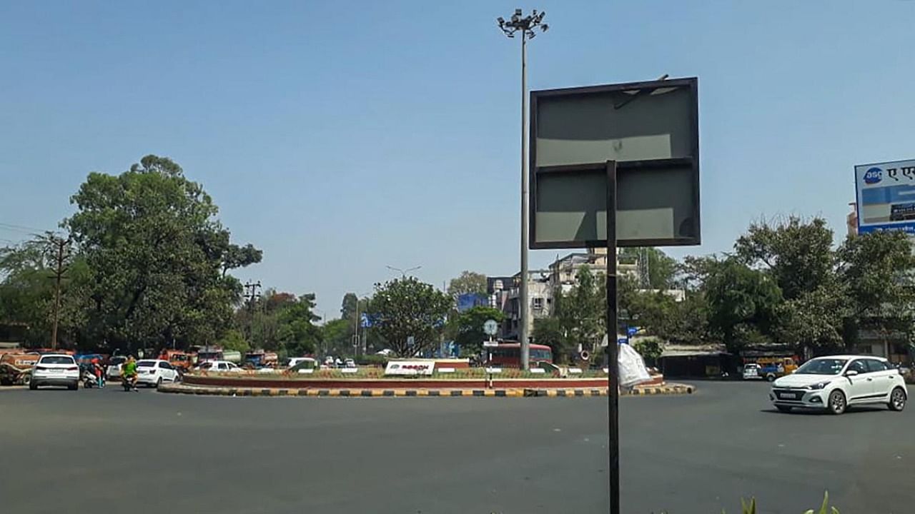 A city street wears a deserted look amid strict restrictions imposed by authorities to curb the spike in coronavirus cases, in Nashik. Credit: PTI.