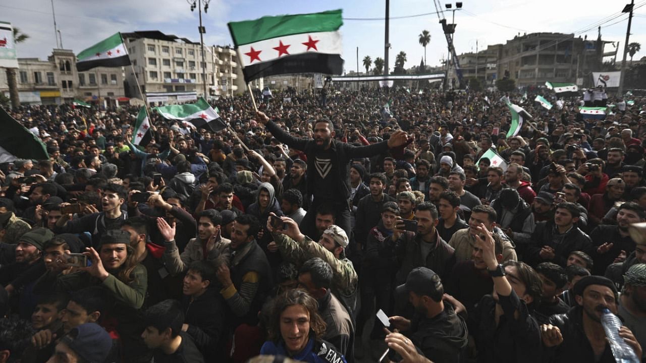 Thousands of anti-Syrian government protesters shout slogans and wave revolutionary flags, to mark 10 years since the start of a popular uprising against President Bashar Assad's rule, that later turned into an insurgency and civil war, In Idlib, the last major opposition-held area of the country, in northwest Syria. Credit: AFP.