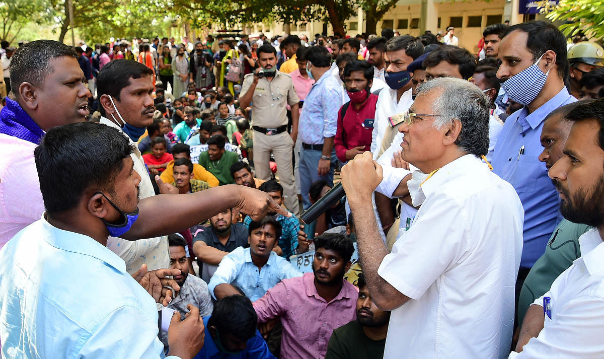 PhD candidates and vice-chancellor K R Venugopal argue during a protest in Bengaluru on Monday. Credit: DH Photo
