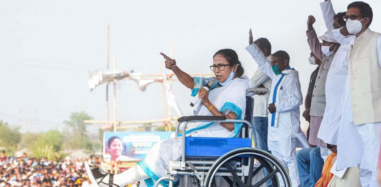 West Bengal Chief Minister Mamata Banerjee addresses a public rally while sitting on a wheelchair, ahead of the state assembly polls, in Purulia district, Monday, March 15, 2021. Credit: PTI Photo