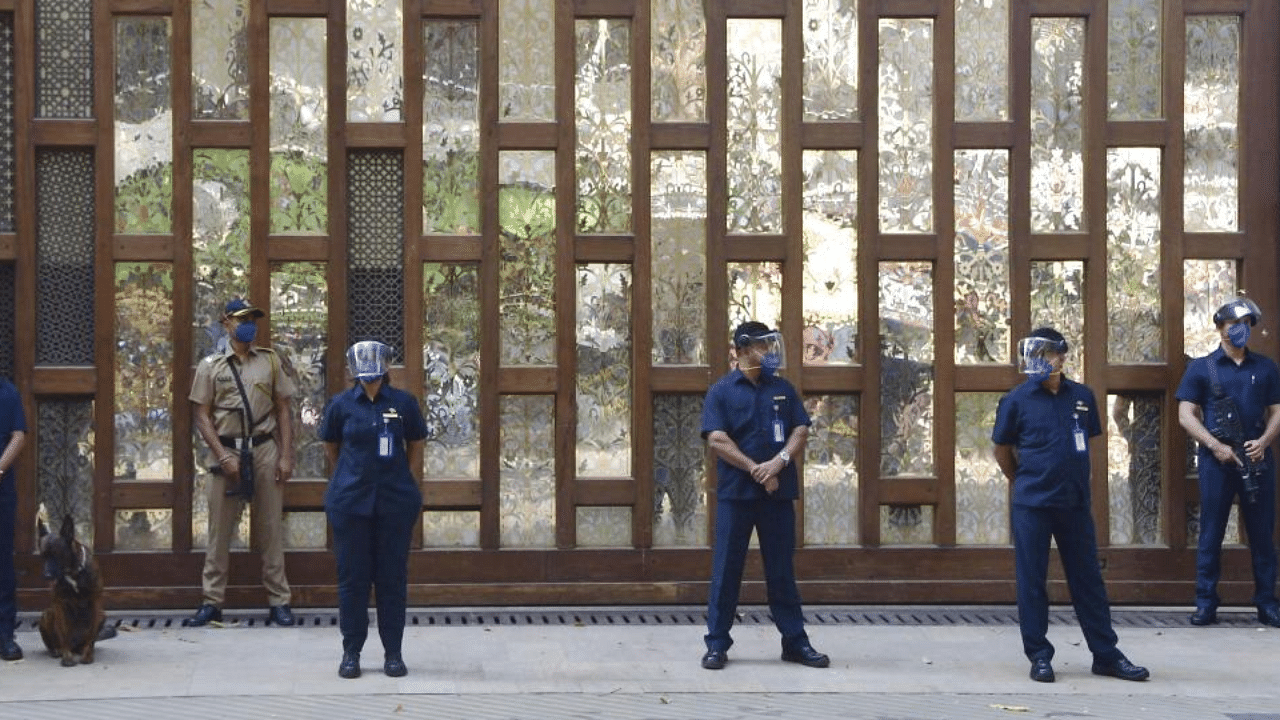  Police personnel guard outside industrialist Mukesh Ambani's residence Antilla, a day after explosives were found in an abandoned car in its vicinity, in Mumbai on Friday, Feb. 26, 2021. Credit: PTI Photo