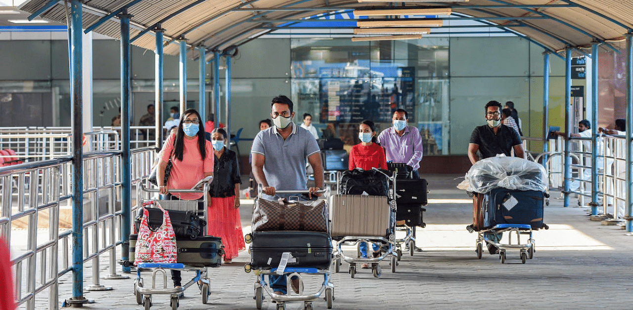 The DGCA said in its circular that passengers shall wear masks and maintain social distancing norms at all times during air travel. Credit: PTI Photo